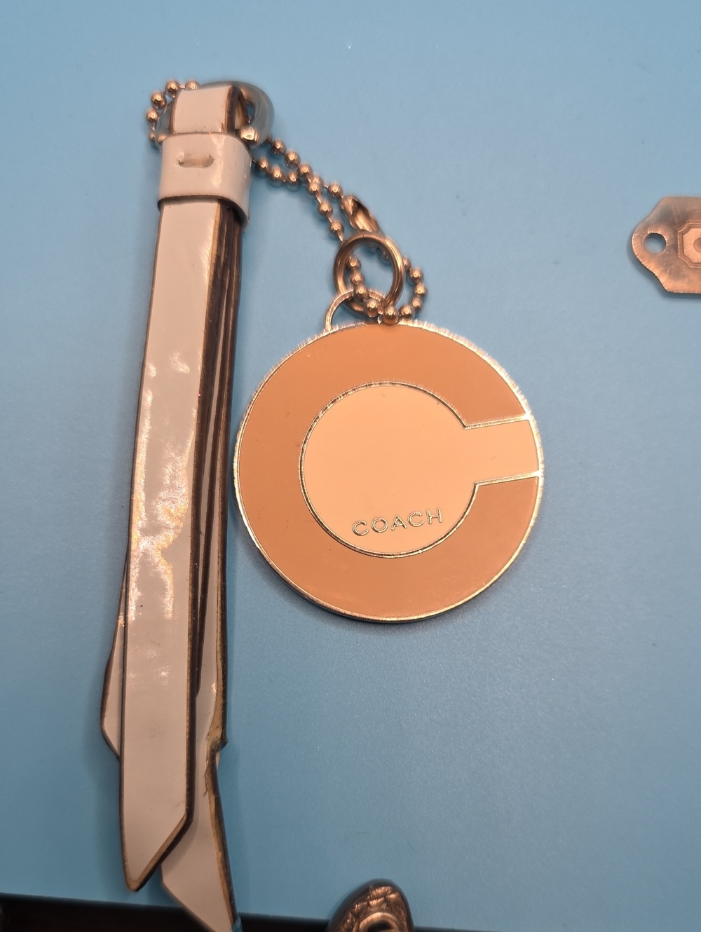 Coach Peach Leather and Gold Round Logo Keychain